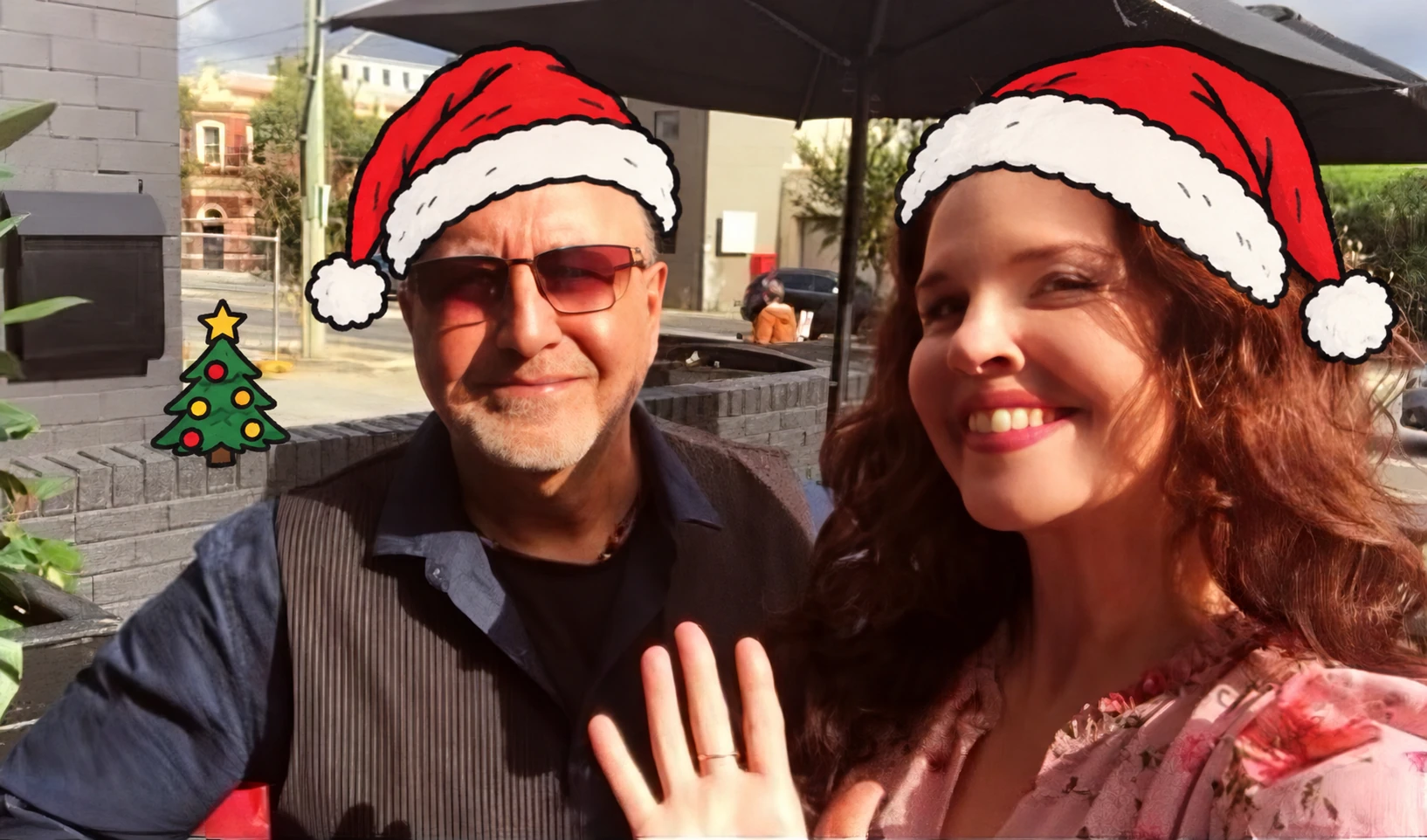 Sarah Maclaine and Paolo Taliana wearing Santa hats